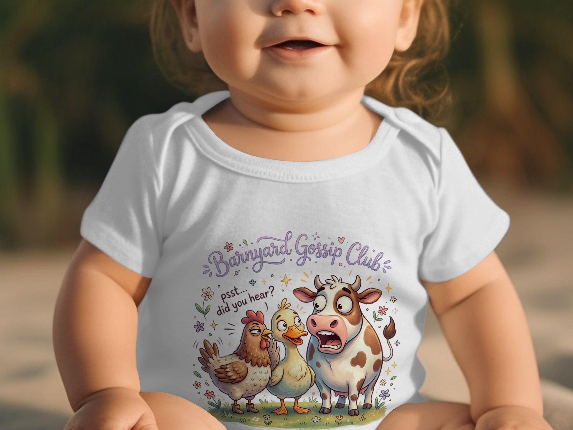 Baby in white bodysuit with "Barnyard Gossip Club" and farm animals graphic.