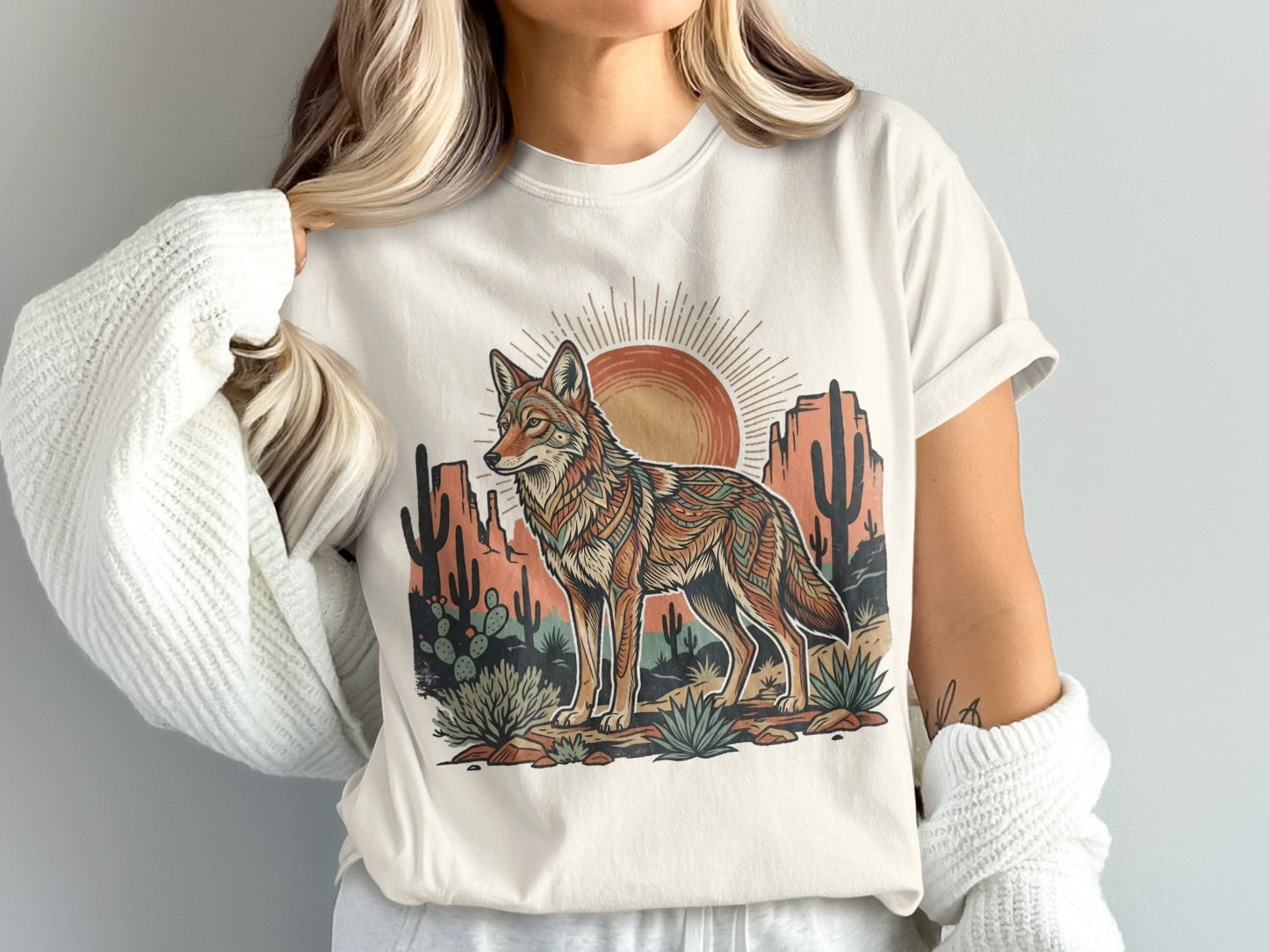 T-shirt with a coyote, desert plants, and sun graphic design.