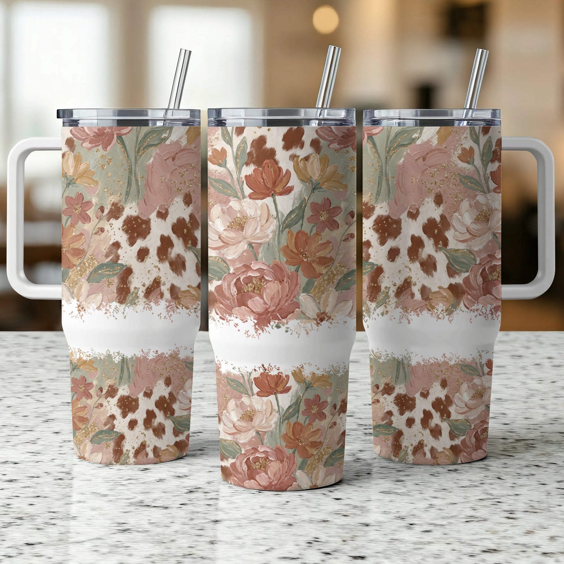 Floral cow print tumbler with handle and straw.