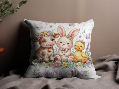 Cow, bunny, and duckling with flowers and "country cuties" text on a pillow.