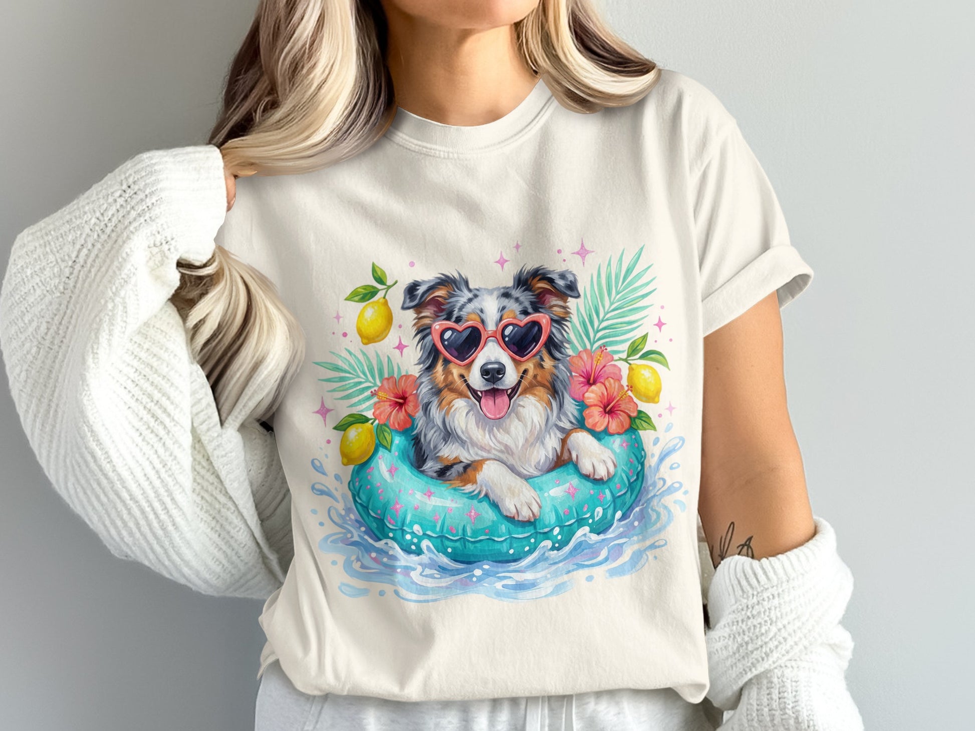 Woman wearing a t-shirt with a happy dog wearing heart sunglasses in a pool float.