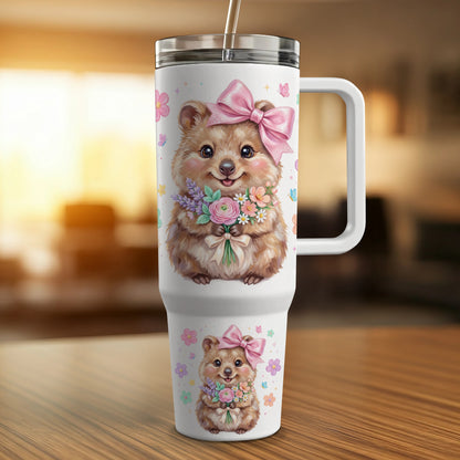 Quokka holding bouquet of flowers wearing pink bow, on white tumbler.