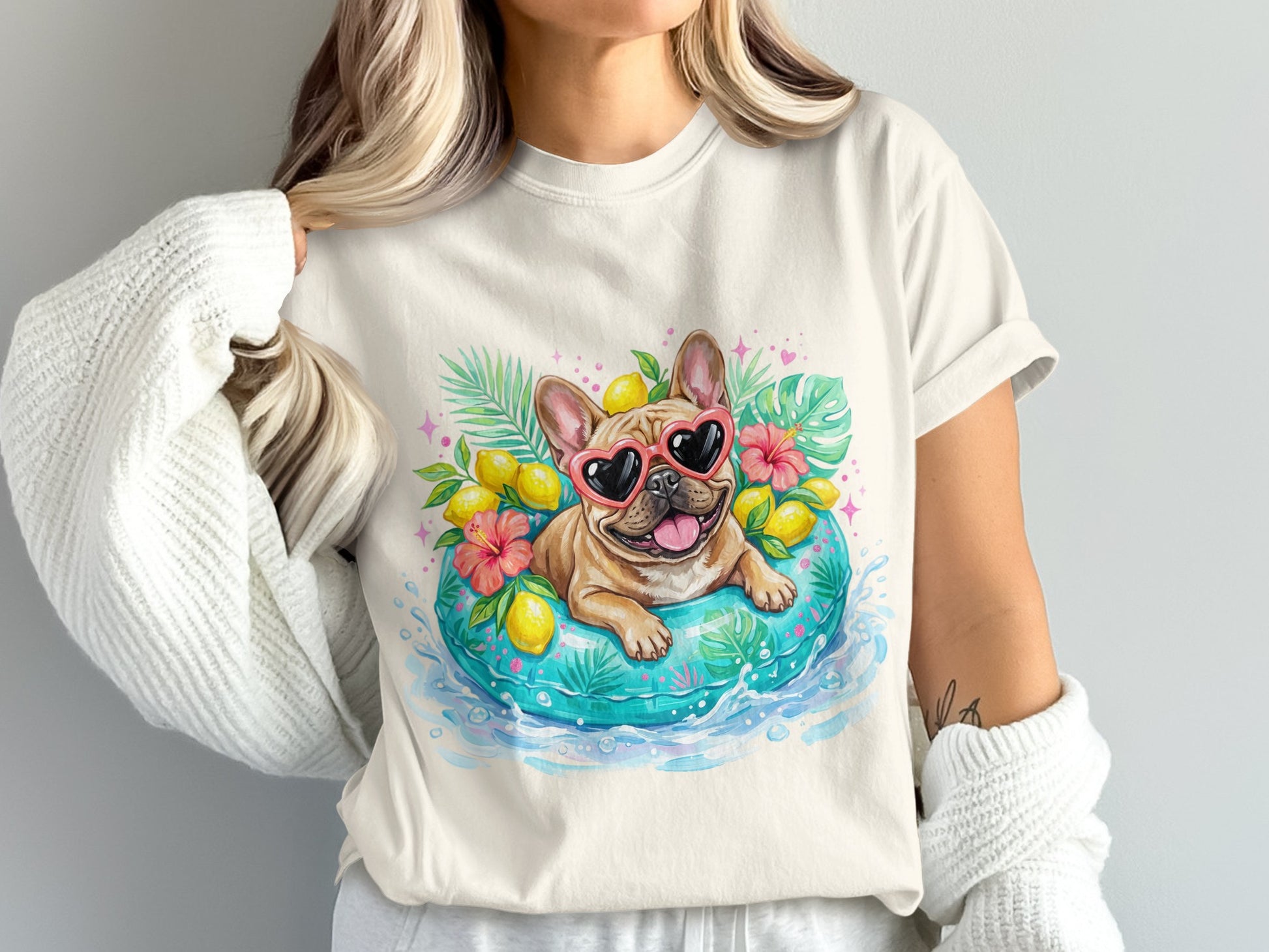 French bulldog wearing heart sunglasses on an inner tube with lemons and tropical leaves.