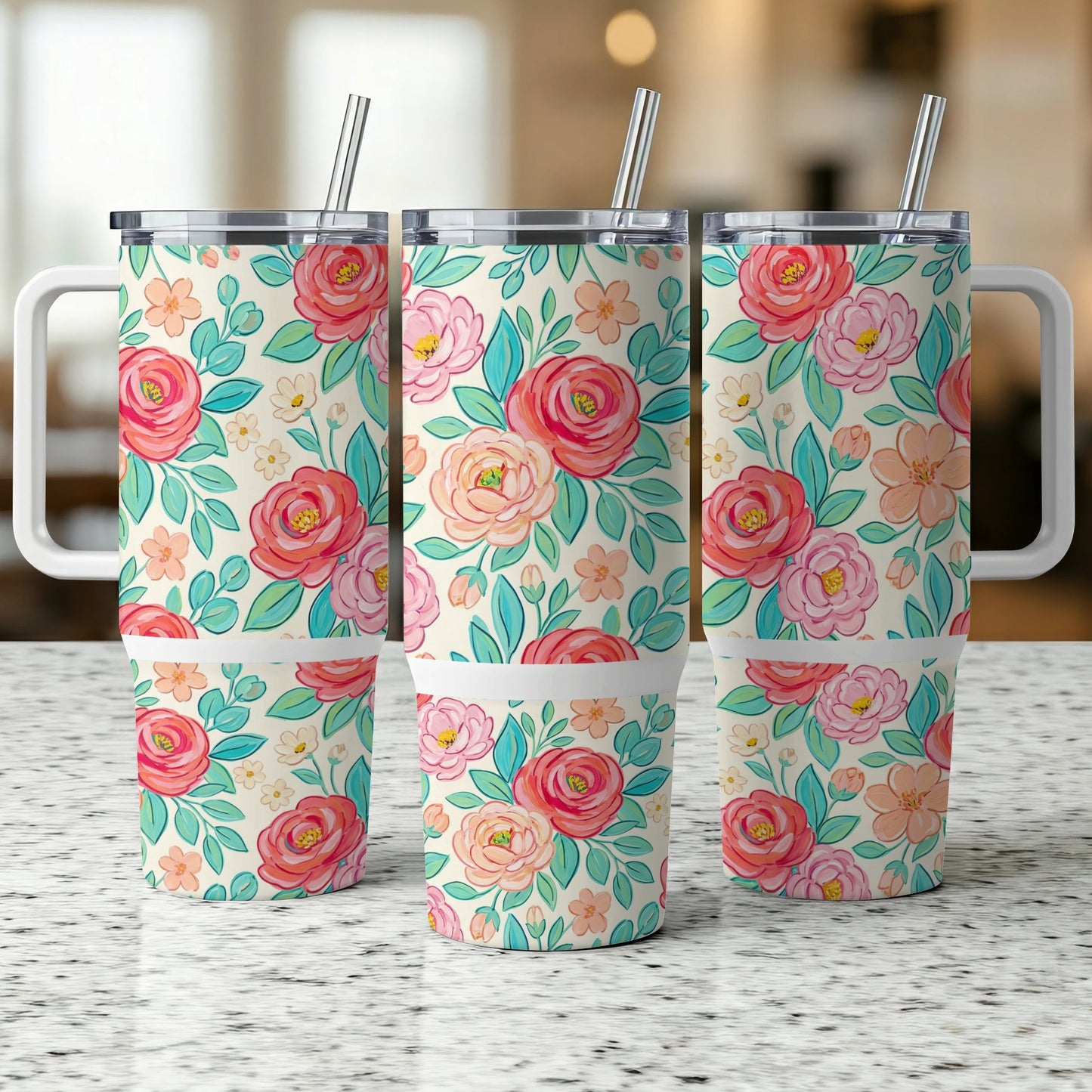 Three tumblers with a floral pattern on a speckled countertop.