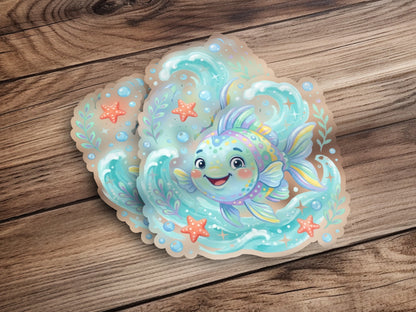 Whimsical cartoon fish sticker with bubbles and starfish on a wooden background.