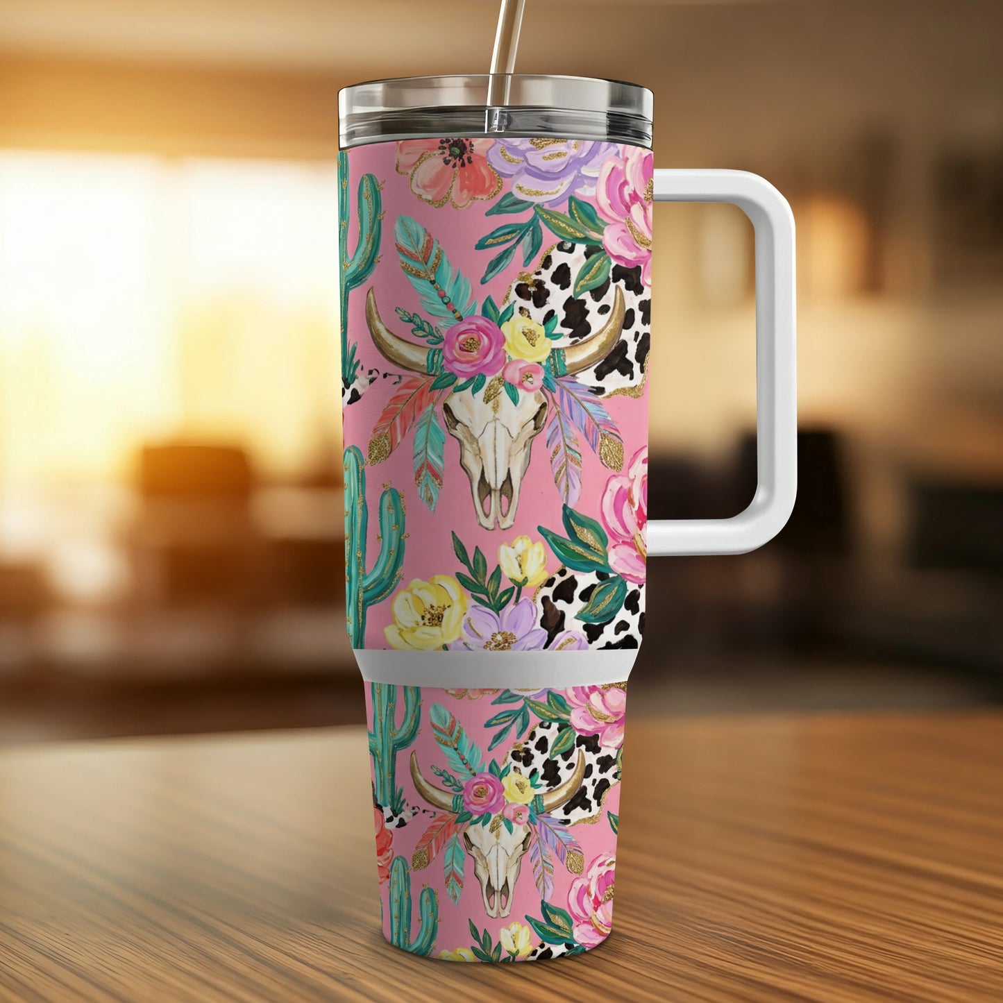 Pink tumbler with floral and cow print pattern, featuring a bull skull and cacti.