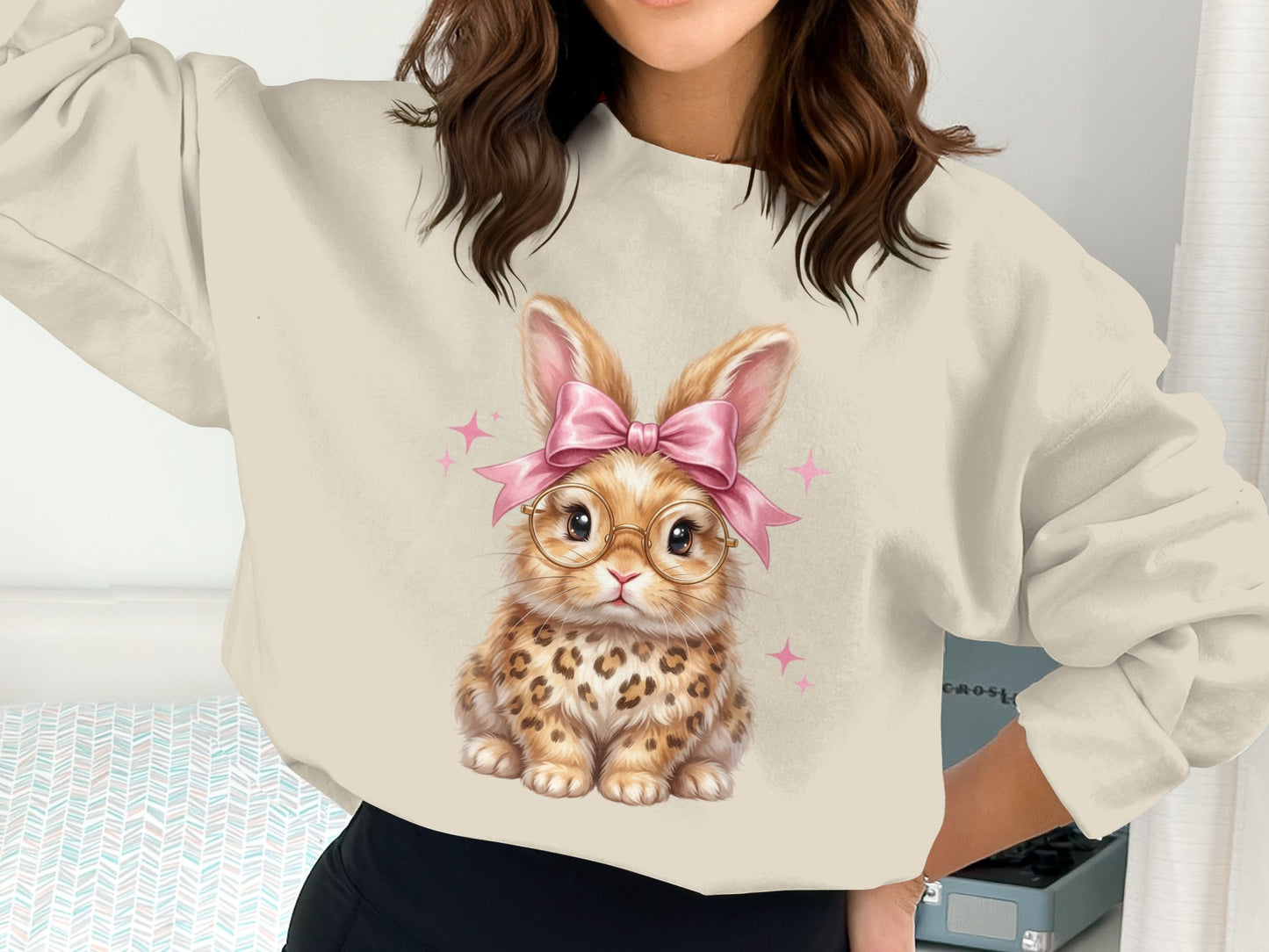 Cream sweatshirt with a cute leopard-print bunny wearing glasses and a pink bow.