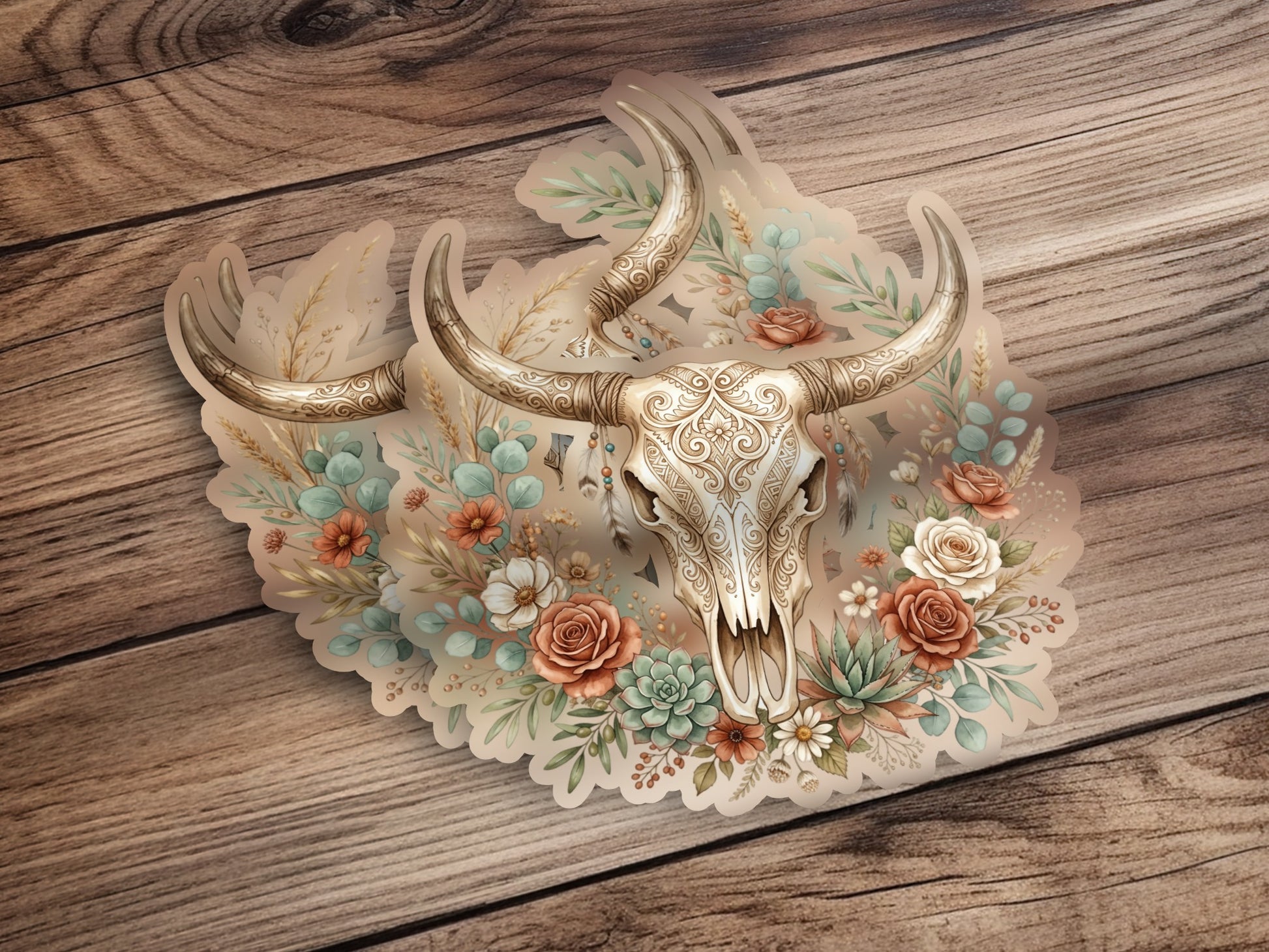 Ornate skull with floral and succulent accents on a wooden background.