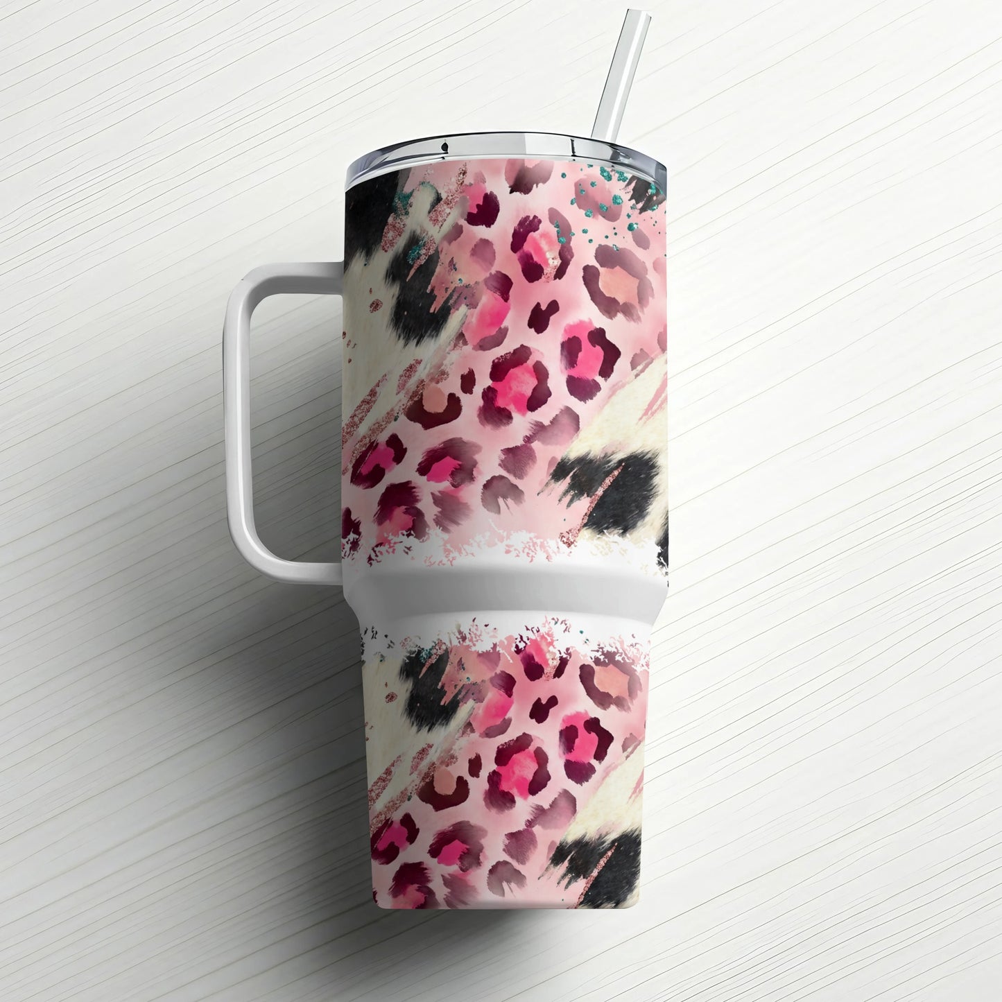 Pink and black leopard print tumbler with handle and straw.