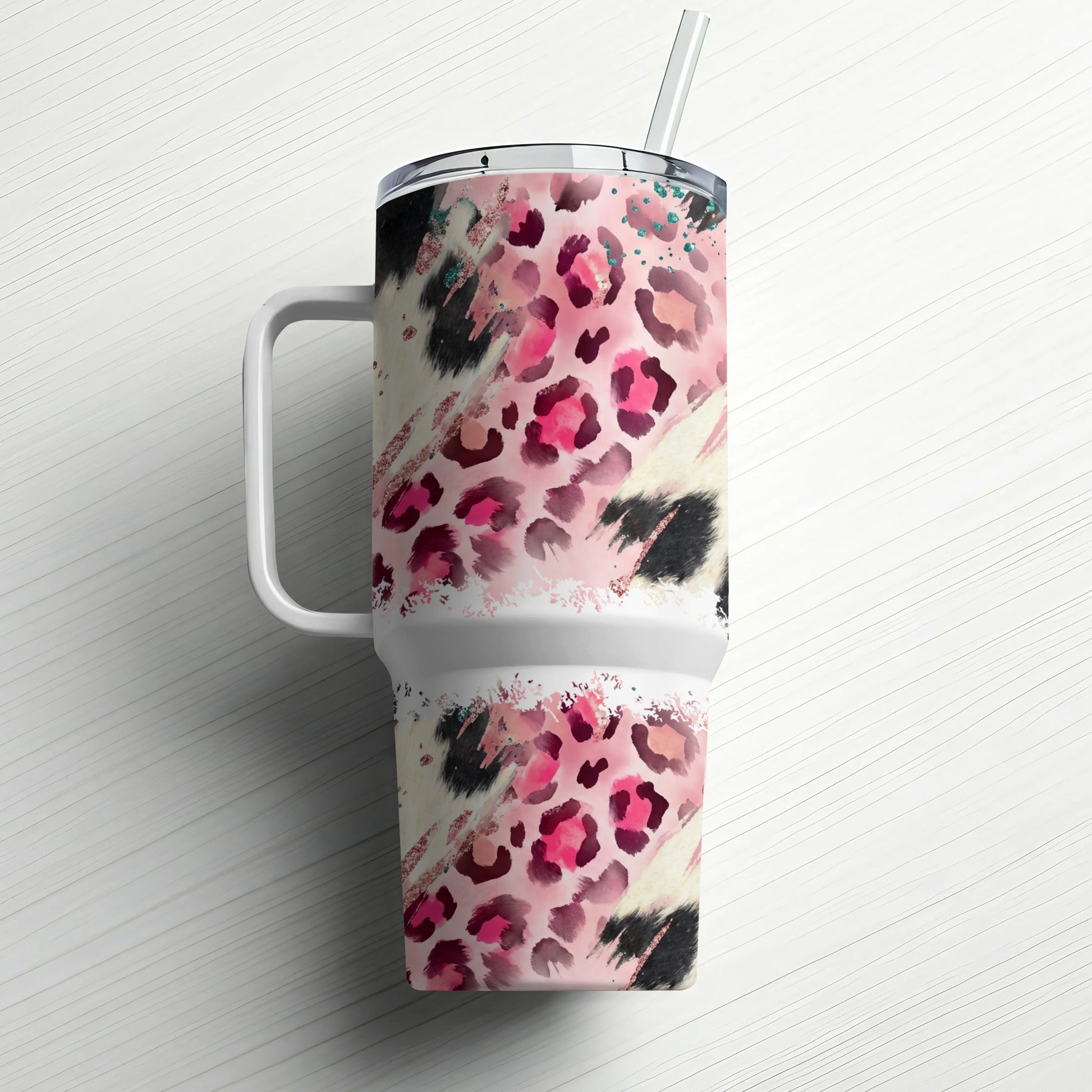 Pink and black leopard print tumbler with handle and straw.