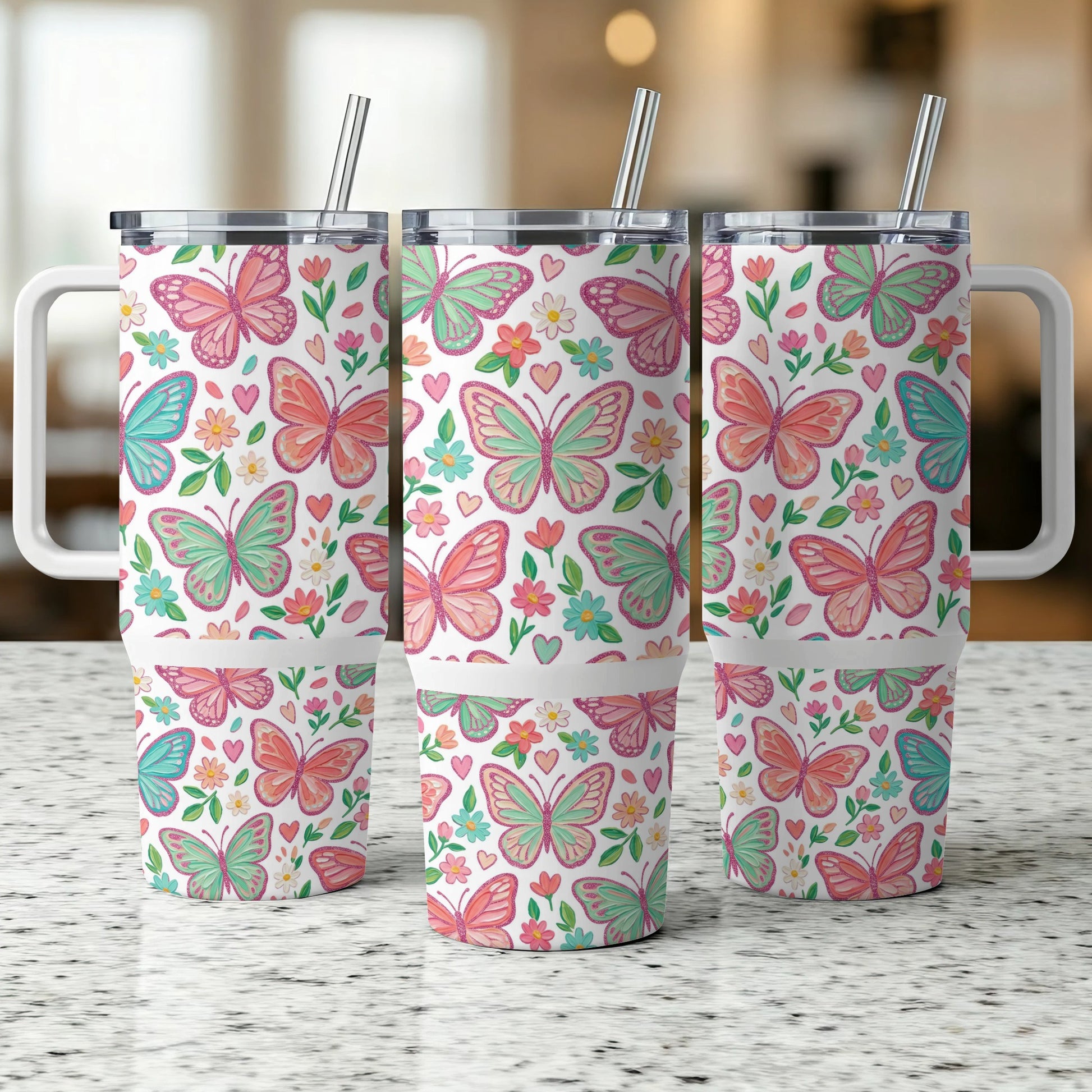 Three insulated tumblers with butterfly and floral patterns.