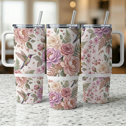 Three tumblers with floral and hummingbird patterns, featuring handles and straws.