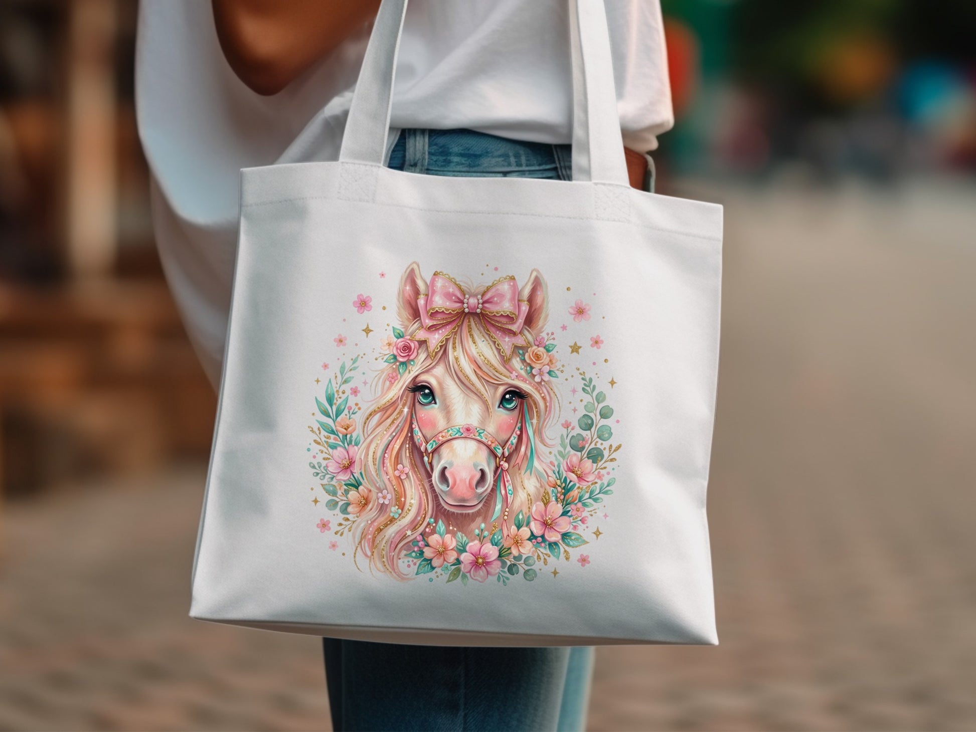 White tote bag with a pink horse illustration surrounded by flowers.