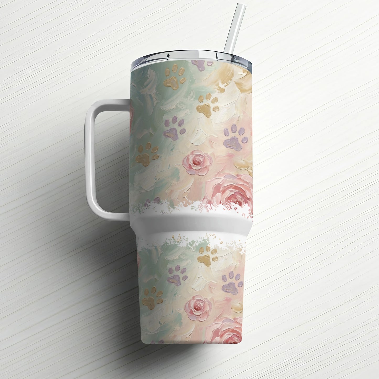 White tumbler with floral and paw print pattern, with handle and straw.
