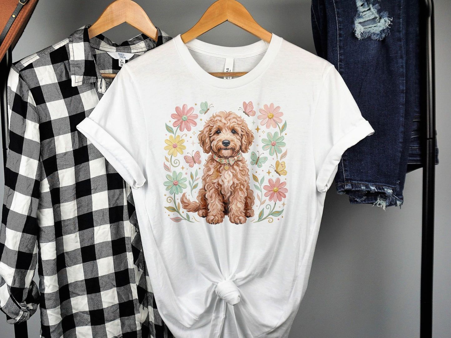 Tan puppy with flowers and butterflies, on a white t-shirt.