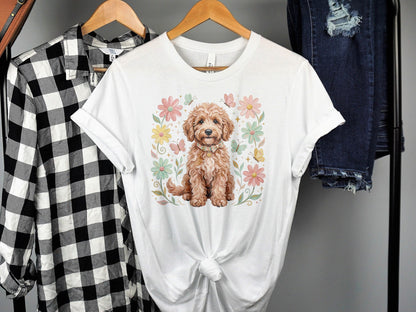 Tan puppy with flowers and butterflies, on a white t-shirt.