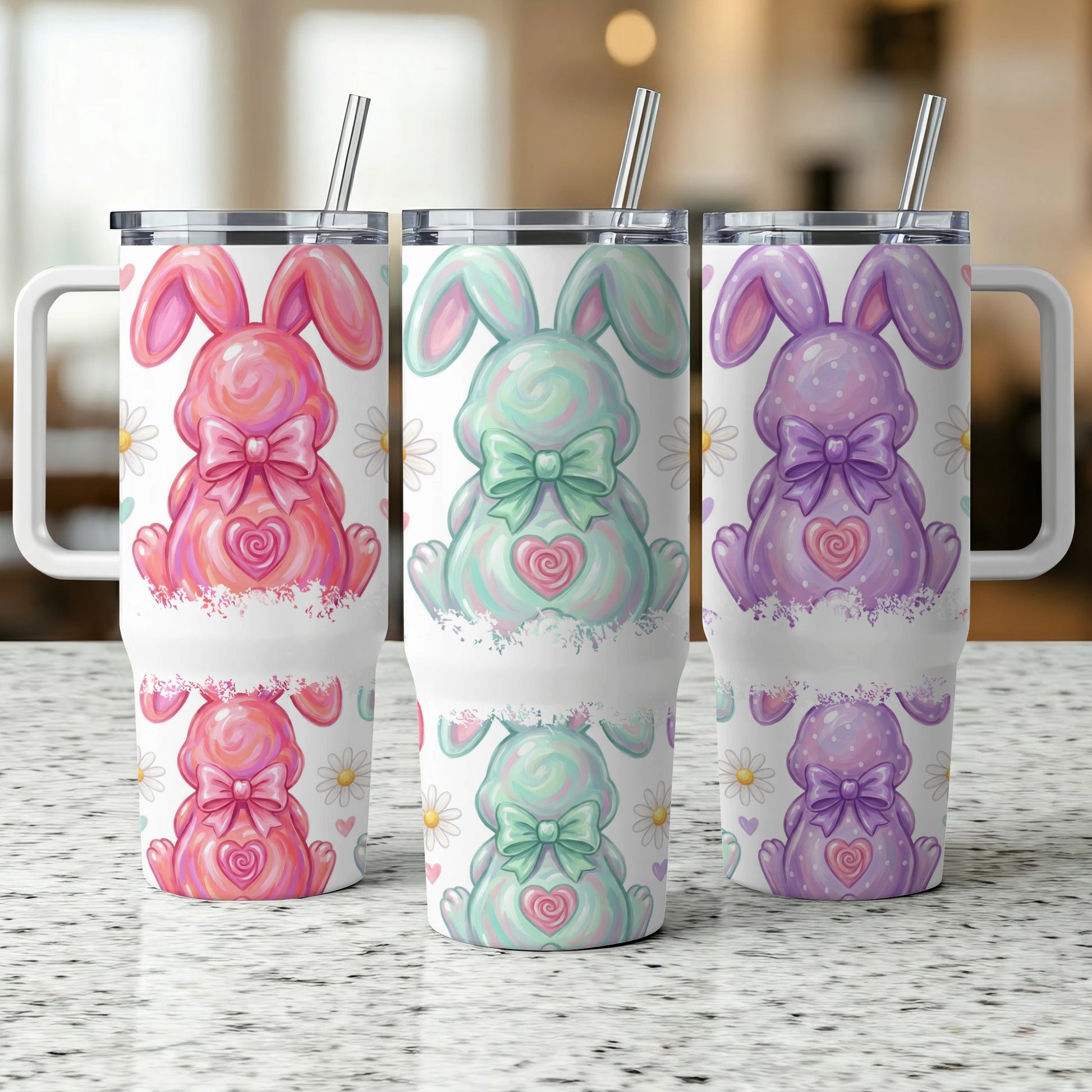 Three Easter bunny tumblers with daisy accents and pastel colors.
