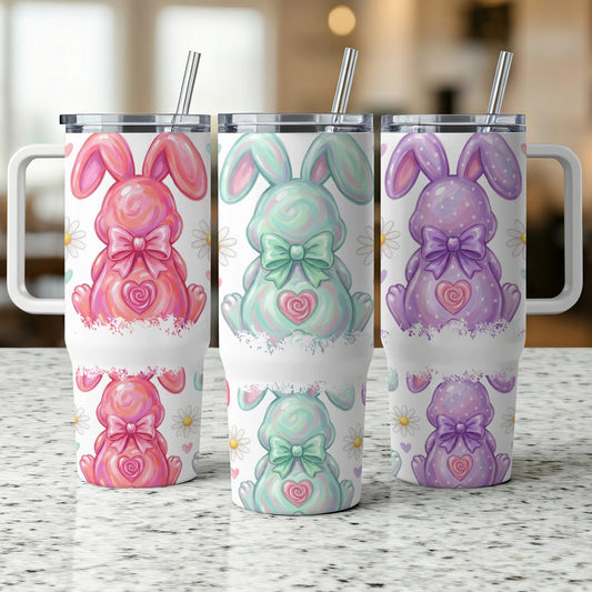 Three Easter bunny tumblers with daisy accents and pastel colors.