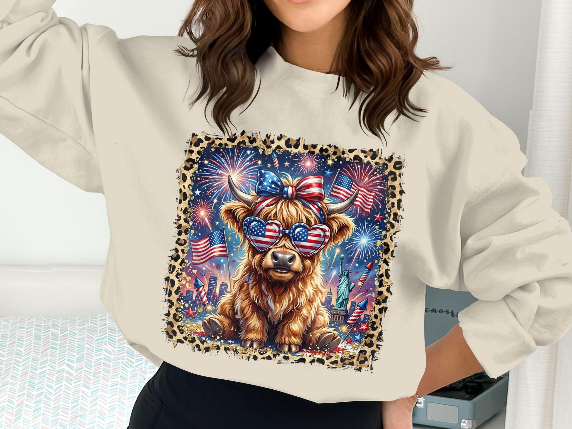 Cow wearing heart-shaped American flag sunglasses with fireworks and Statue of Liberty background.