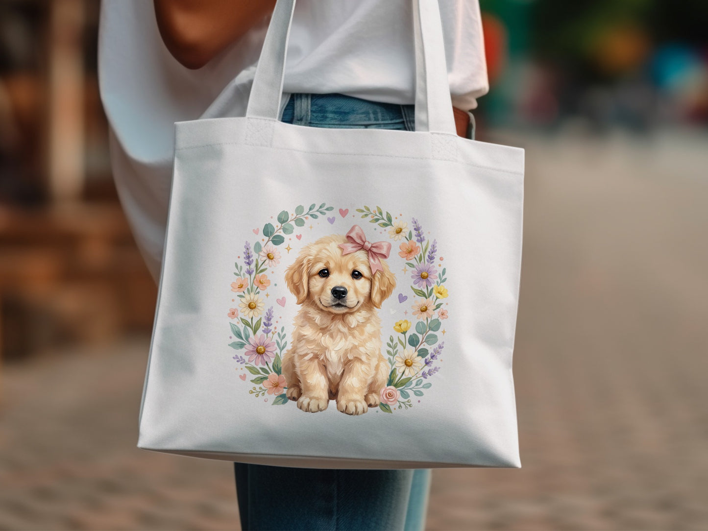 Golden retriever puppy wearing a pink bow, surrounded by floral wreath, on white tote bag.