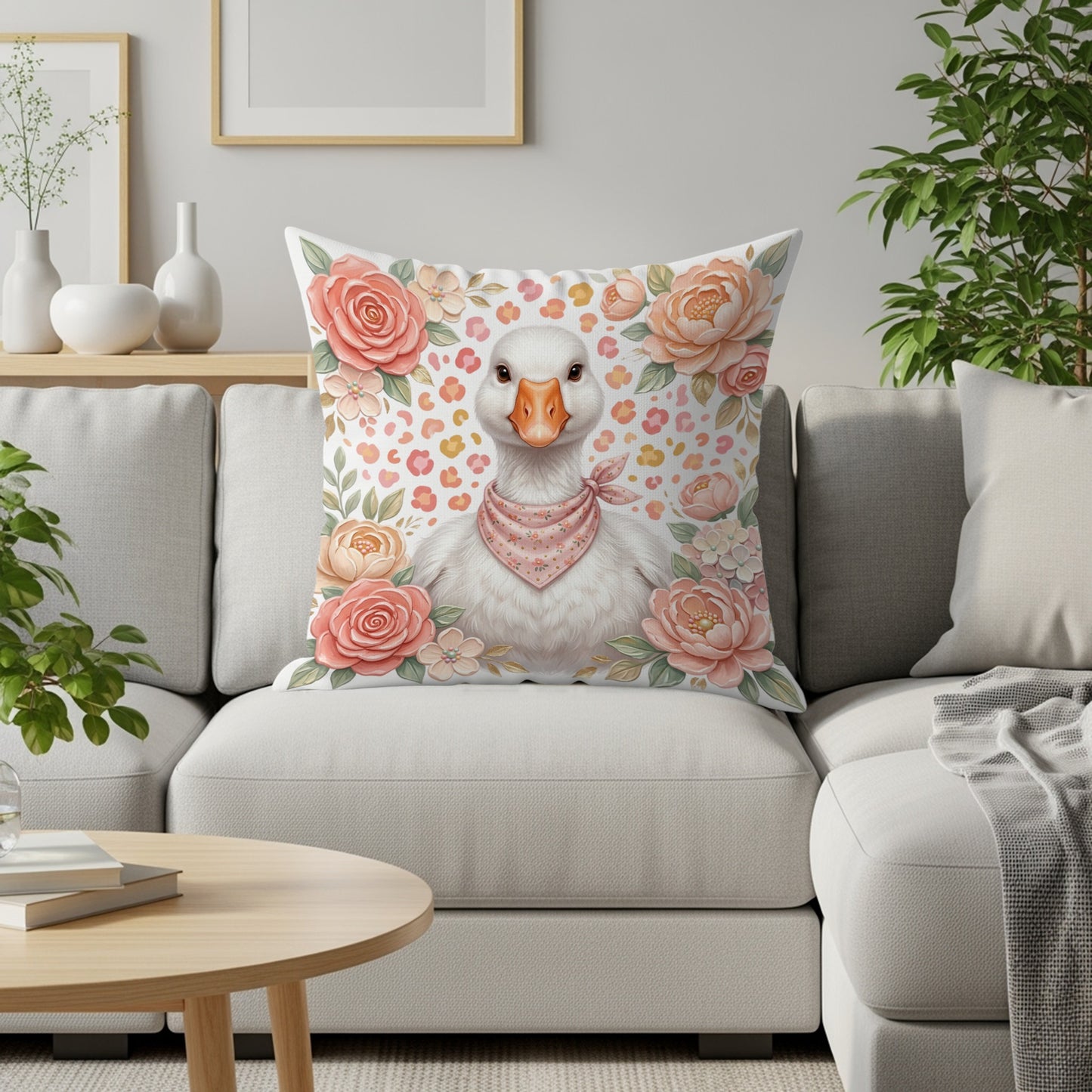 Goose with pink bandana on floral pillow on couch.