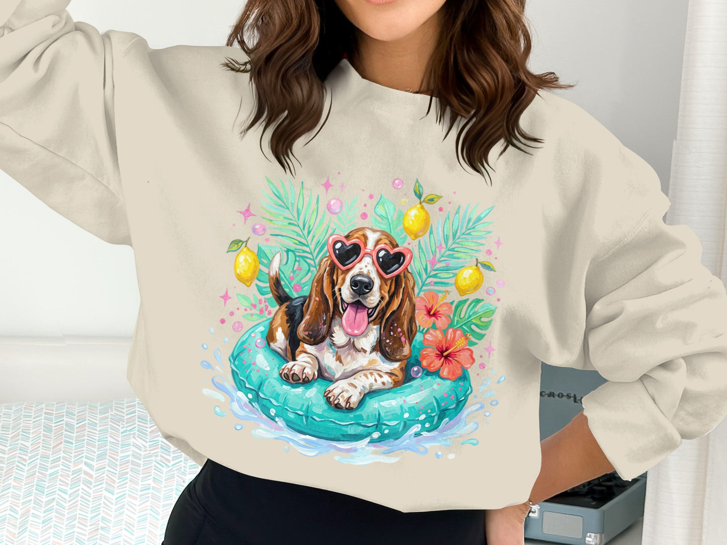 Basset hound in sunglasses on an inflatable with tropical leaves and lemons.