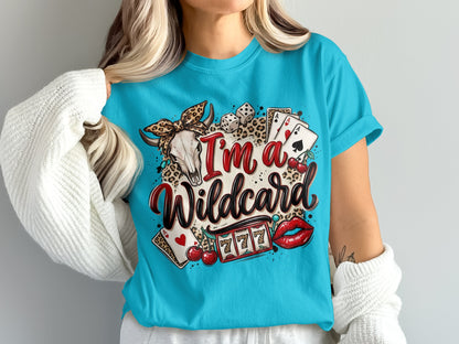 Woman wearing a blue t-shirt with "I'm a Wildcard" text, skull, dice, and cherries.