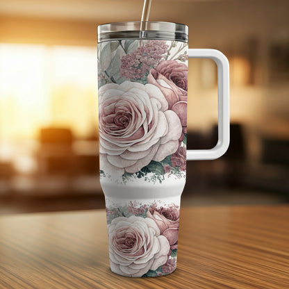Large insulated tumbler with pink roses and a white handle.