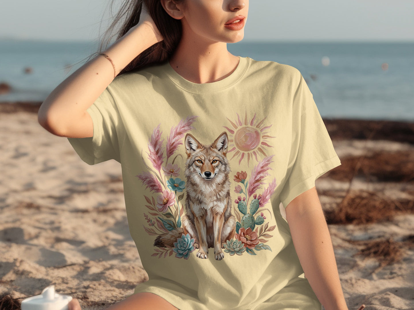 Coyote and floral design on a light yellow t-shirt.