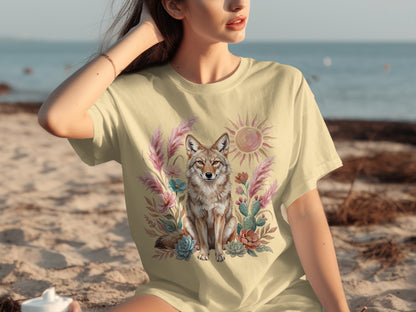 Coyote and floral design on a light yellow t-shirt.