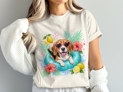 Beagle wearing heart sunglasses in a pool float surrounded by tropical leaves and fruit.
