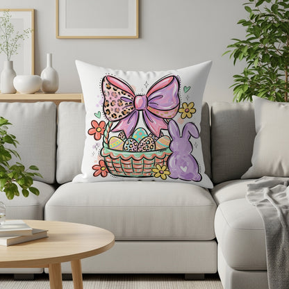 Easter basket with bow, eggs, and bunny illustration on a pillow.