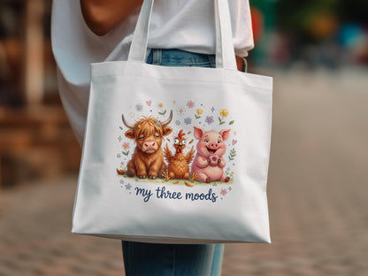 Tote bag with cow, chicken, and pig characters wearing donuts and flowers.