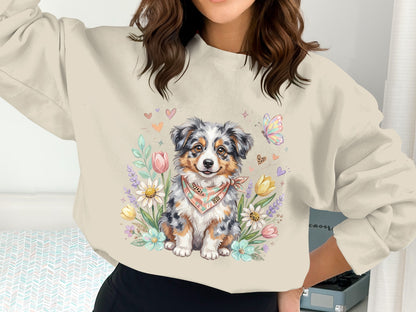 Sweatshirt with a cheerful Australian Shepherd puppy among flowers and hearts.