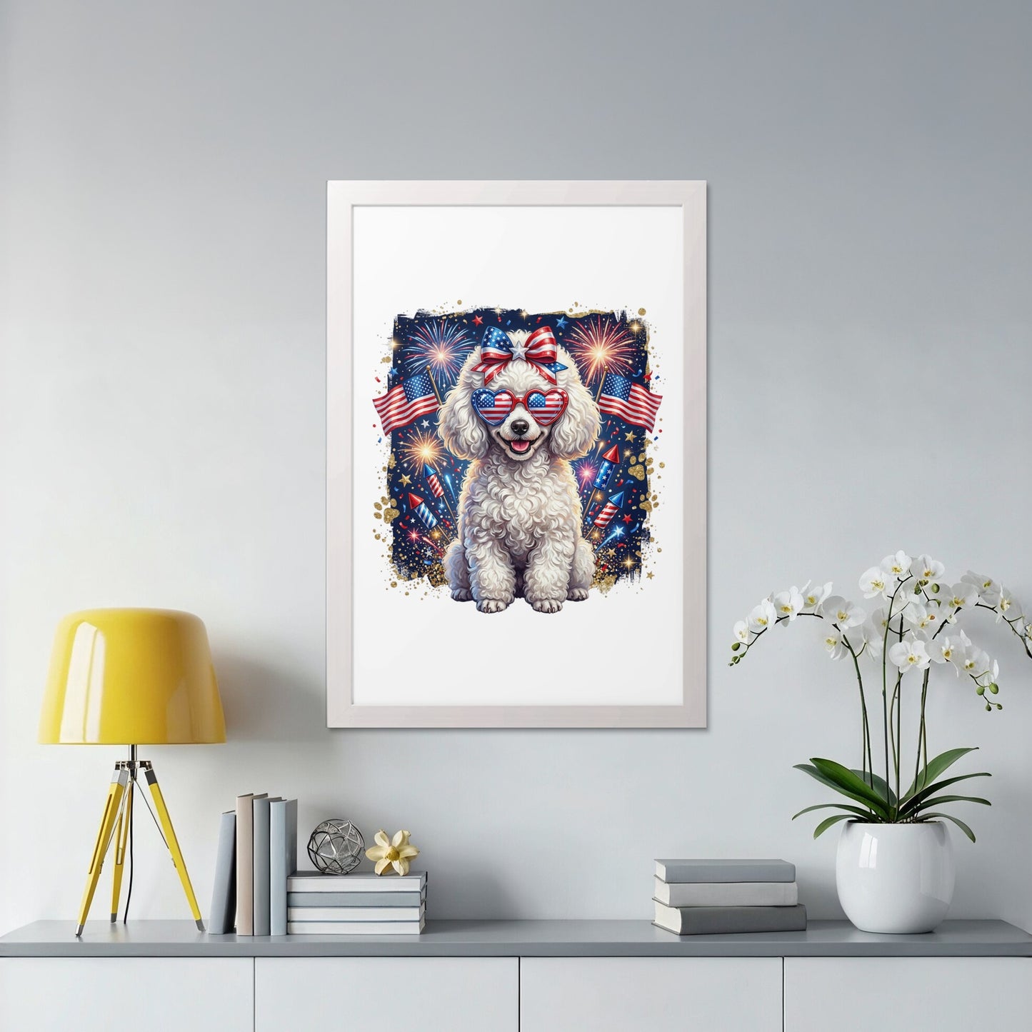 White poodle wearing American flag sunglasses and bow, with fireworks behind.
