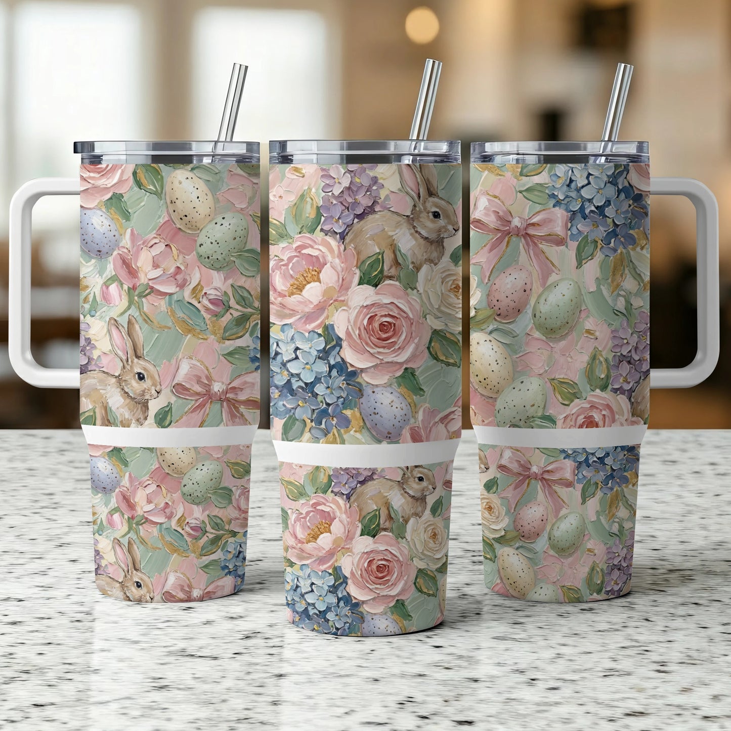 Three tumblers with Easter floral and bunny patterns sit on a counter.