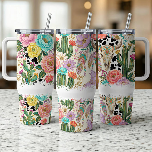 Floral and cactus patterned tumblers with cow skull and feather designs.