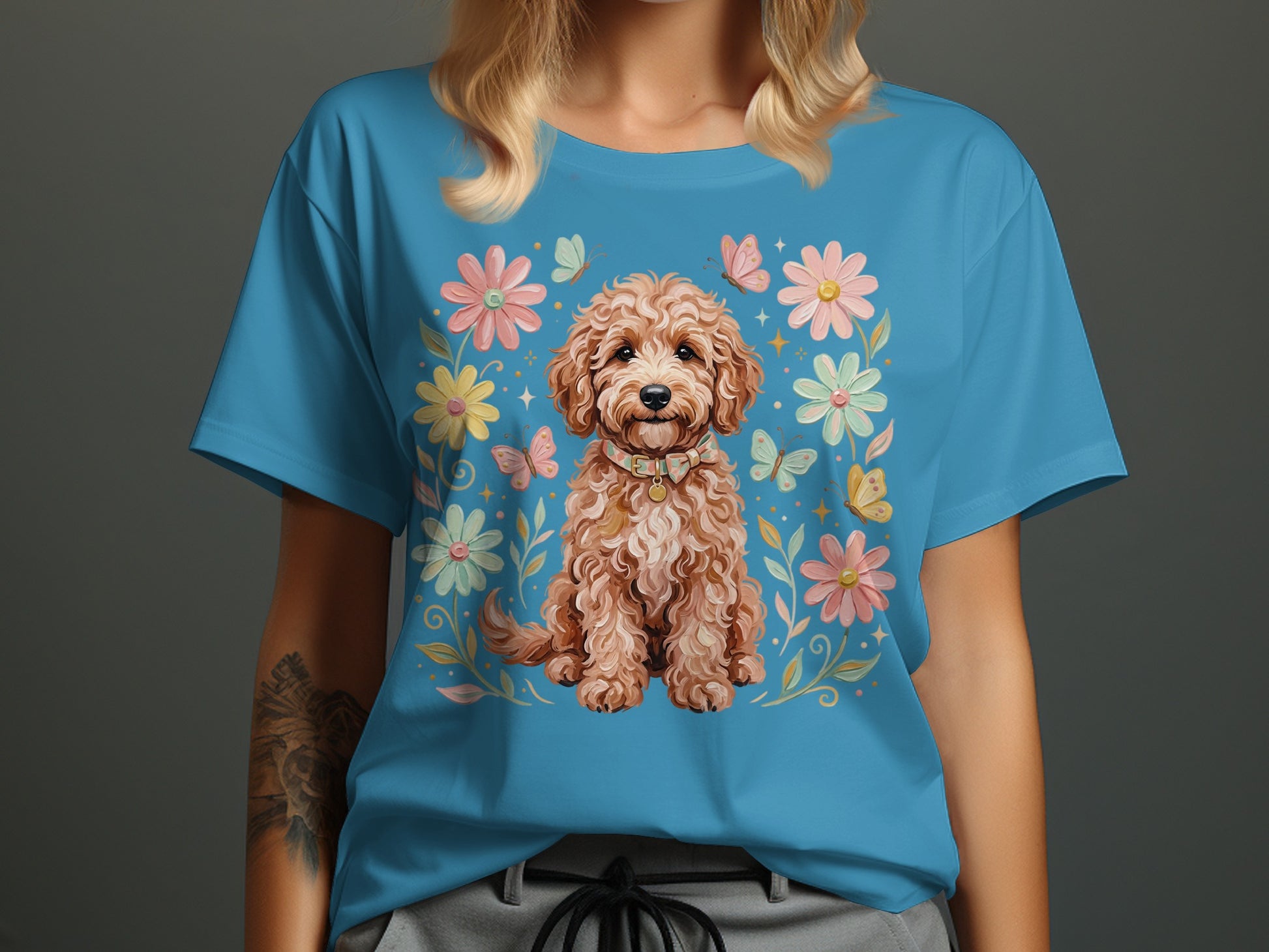Blue t-shirt featuring a small brown dog with floral and butterfly border.