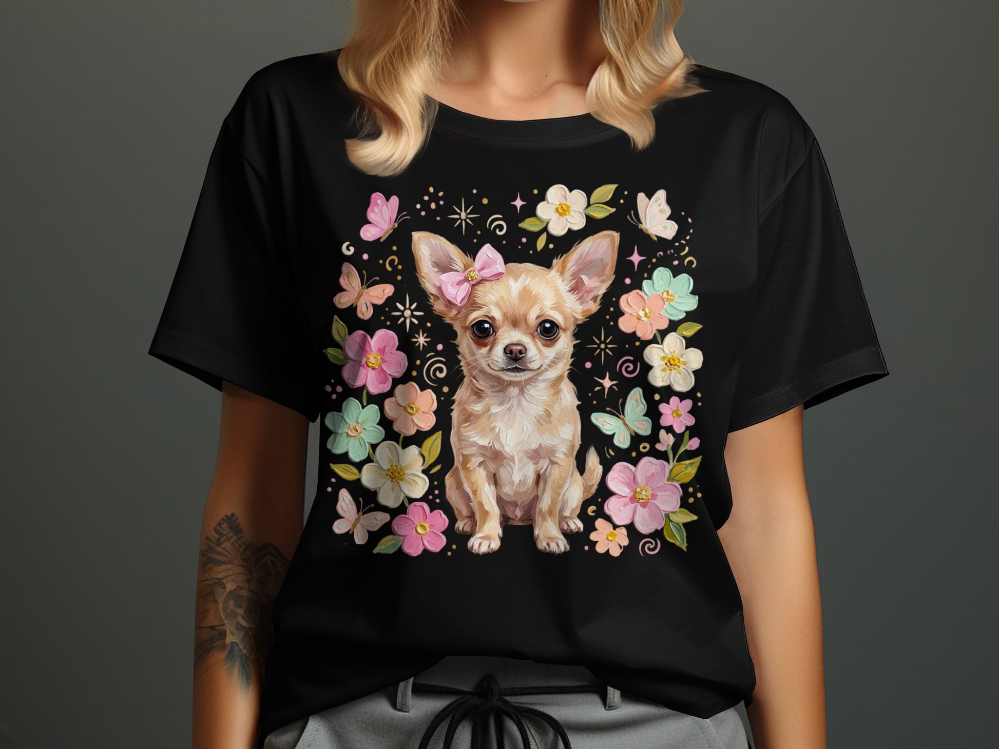 Black t-shirt with chihuahua wearing a pink bow, surrounded by flowers and butterflies.