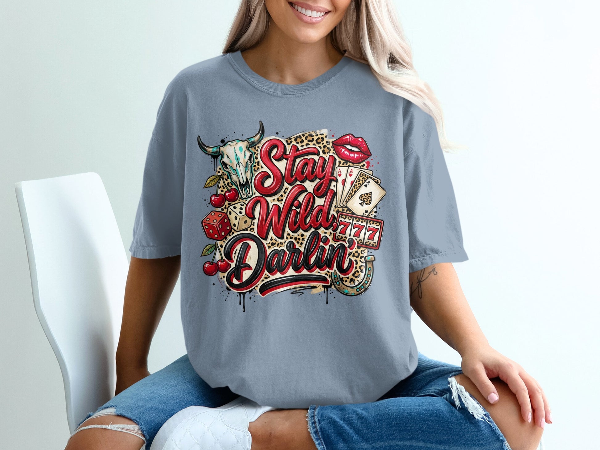T-shirt with "Stay Wild Darlin'" text and cowboy skull, cards, and dice graphics.
