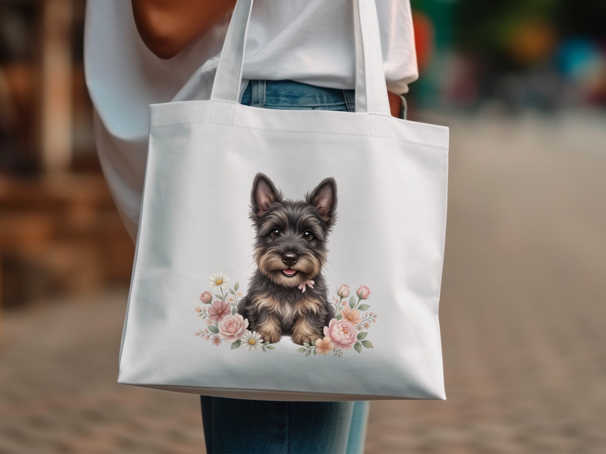 White tote bag with a painted Yorkshire terrier surrounded by pink and white flowers.