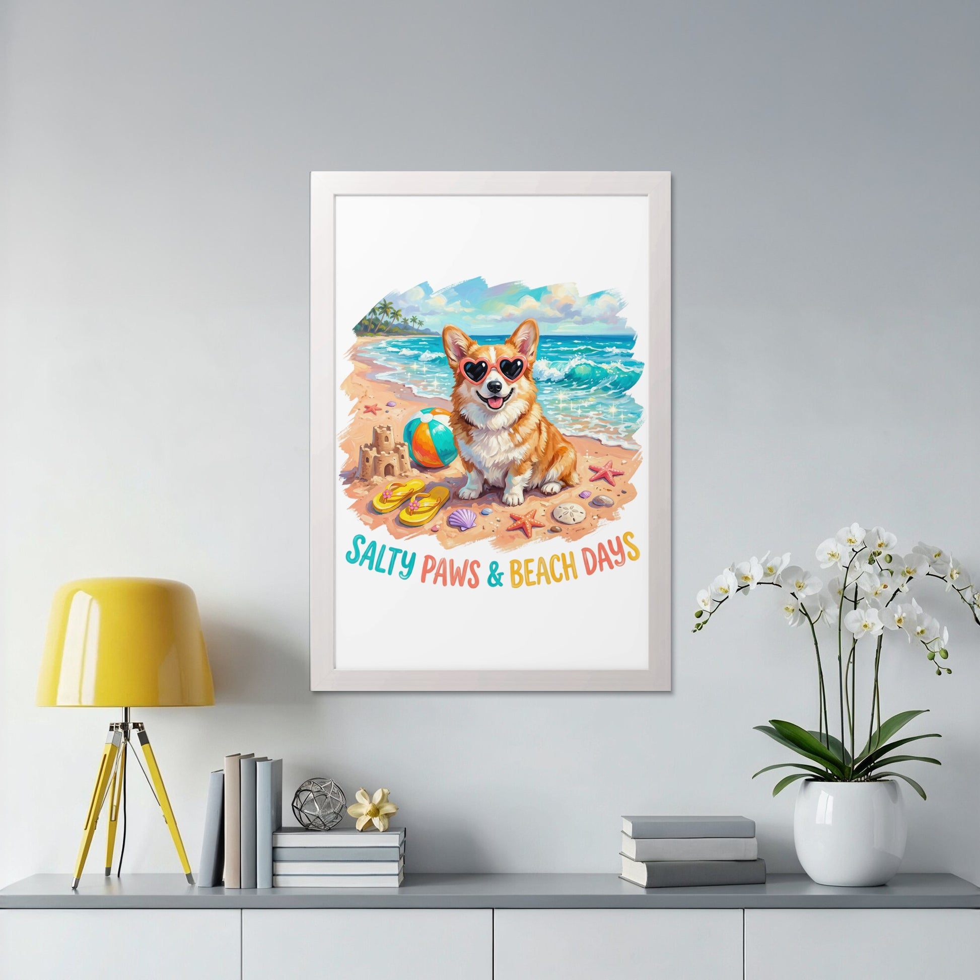 Corgi wearing heart sunglasses sits on a beach with a ball and starfish.