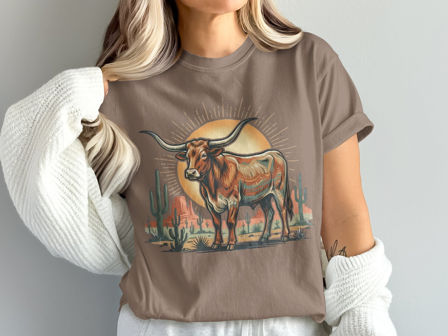 Brown graphic tee with a colorful longhorn and desert landscape under a sun.