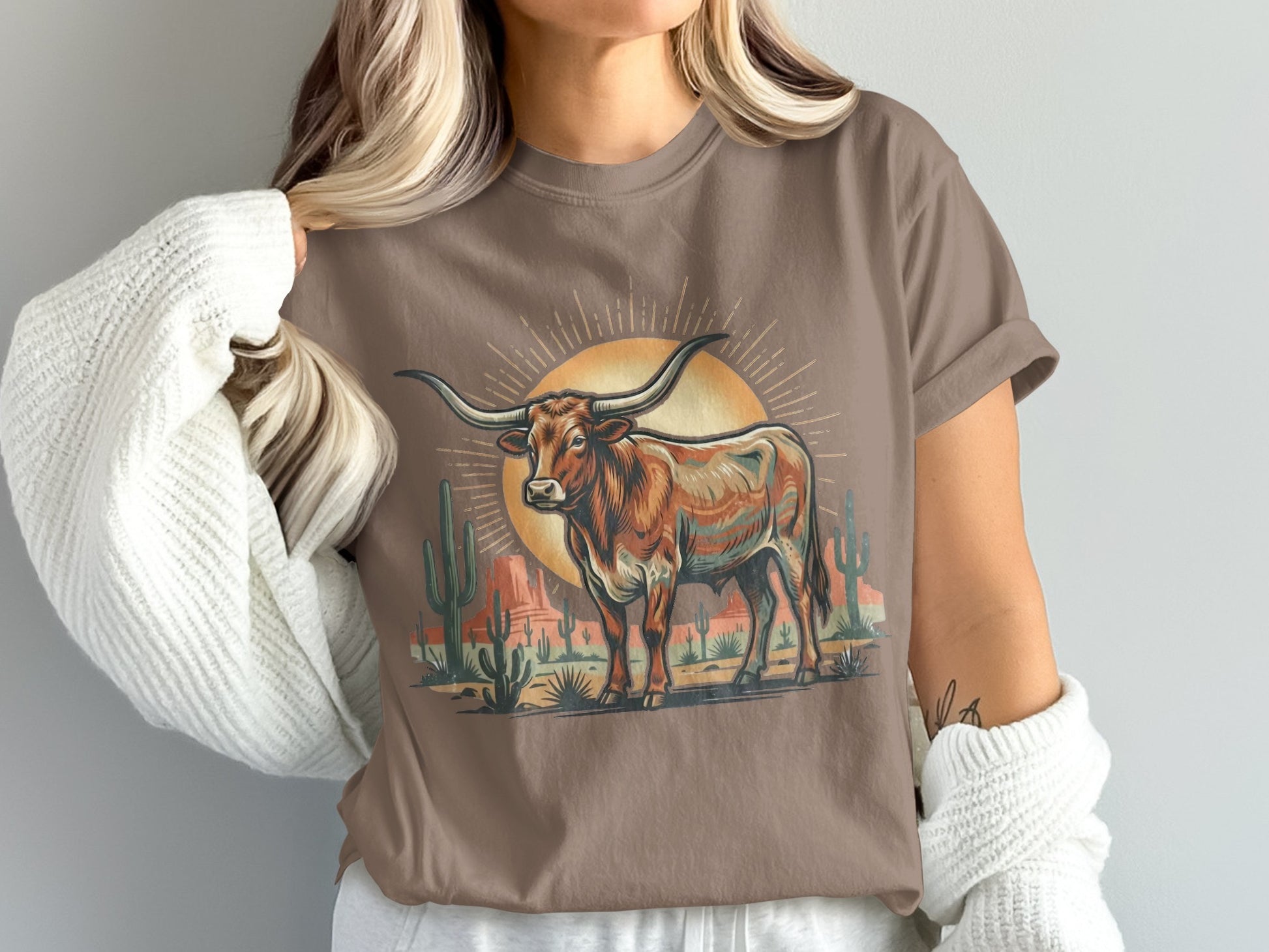 Brown graphic tee with a colorful longhorn and desert landscape under a sun.