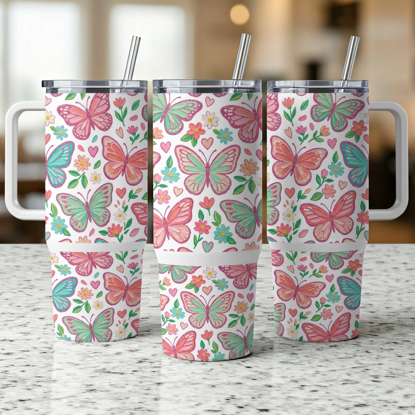Three insulated tumblers with butterfly and floral pattern, white lids, and straws.