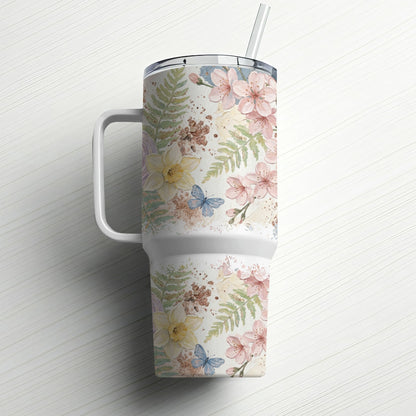 Tumbler with floral and butterfly pattern and straw.