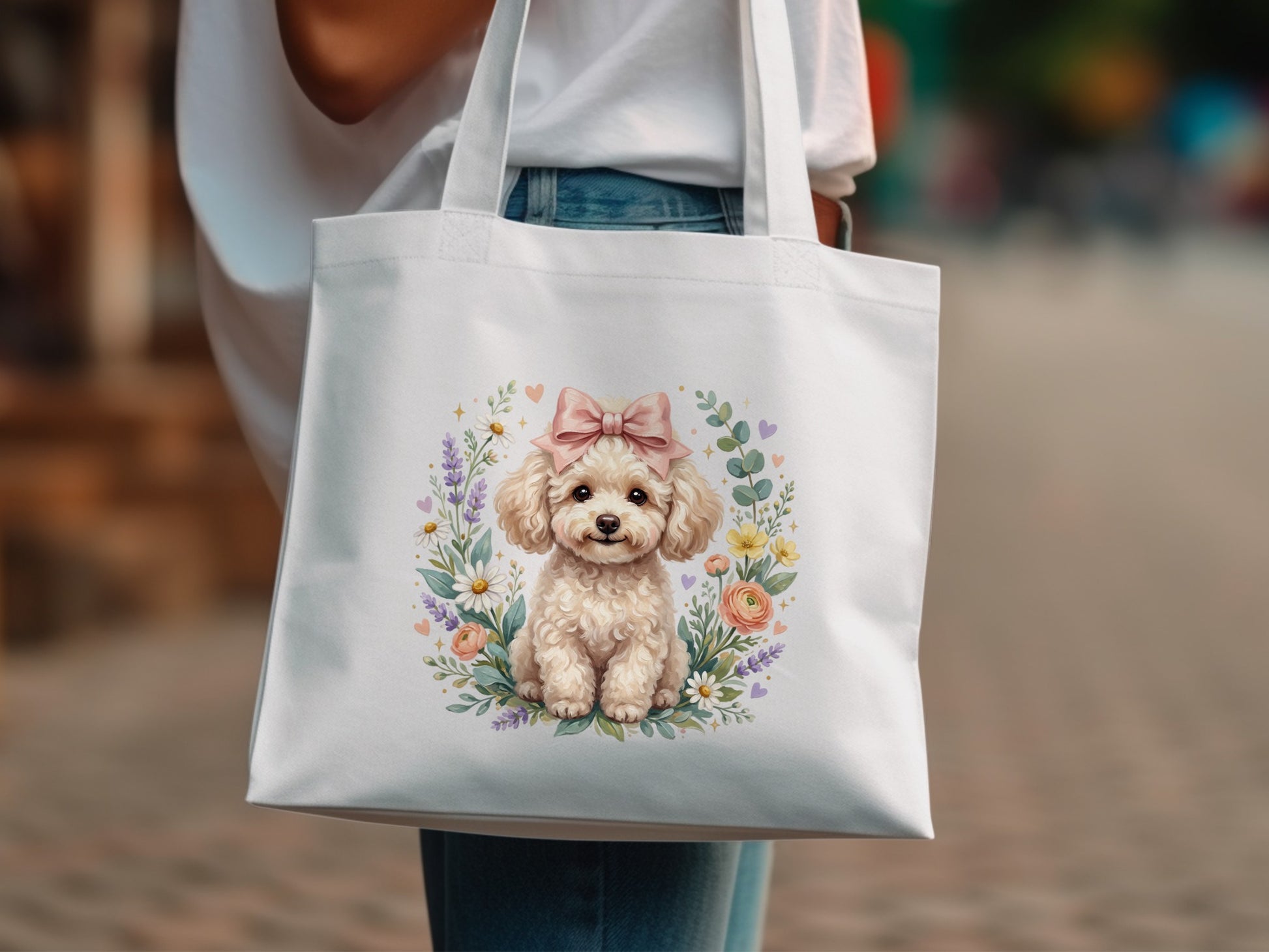 White tote bag with watercolor poodle wearing pink bow surrounded by floral wreath.