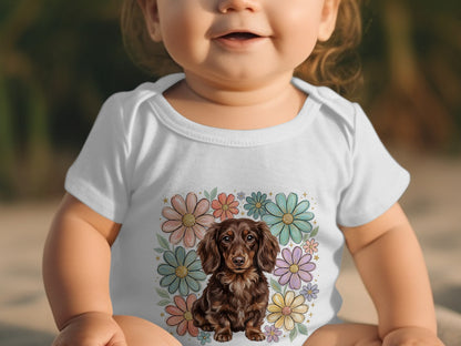 Baby wearing white bodysuit with a brown dachshund and floral graphic.