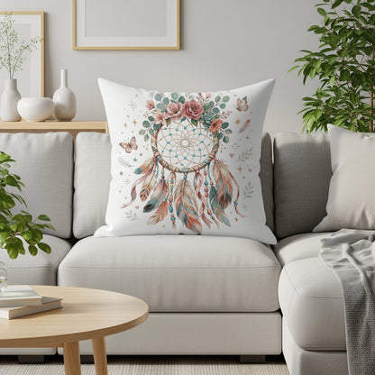 Dreamcatcher pillow with floral accents on a white couch.
