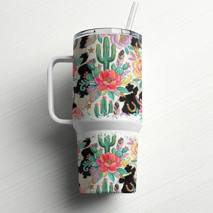 Floral, cactus, and cow print tumbler with straw and handle.